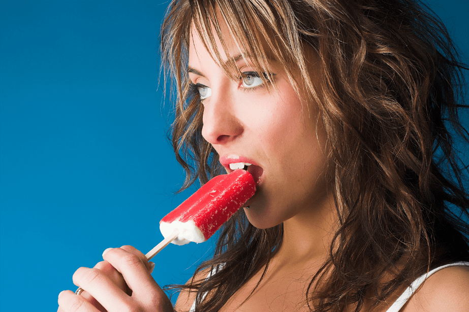 A pretty woman putting a red popsicle up to her lips, showing the power and draw of digital marketing for small businesses